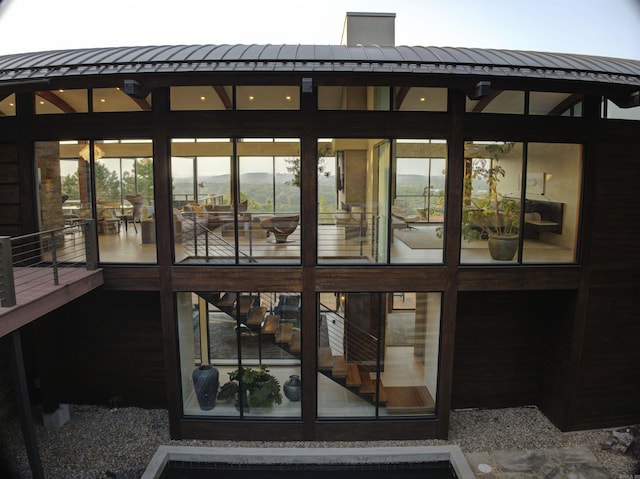 rear view of property with a sunroom