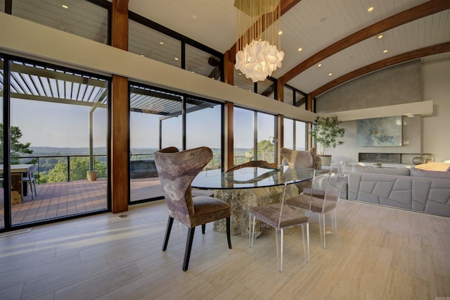 dining space featuring an inviting chandelier and lofted ceiling