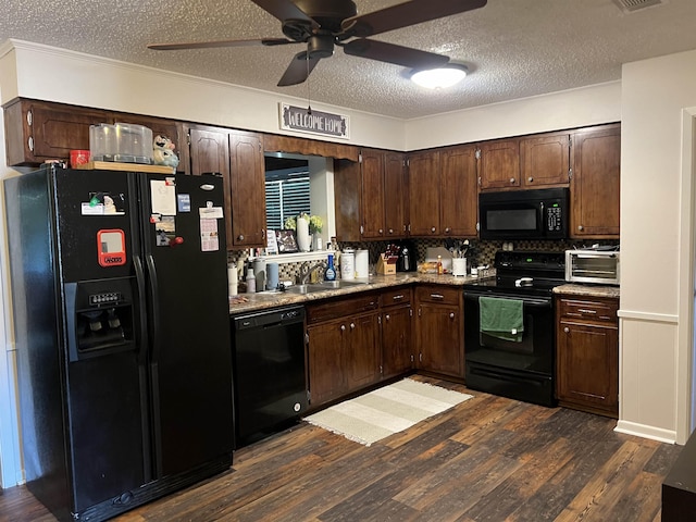 kitchen with black appliances, dark wood-type flooring, a sink, and dark brown cabinetry