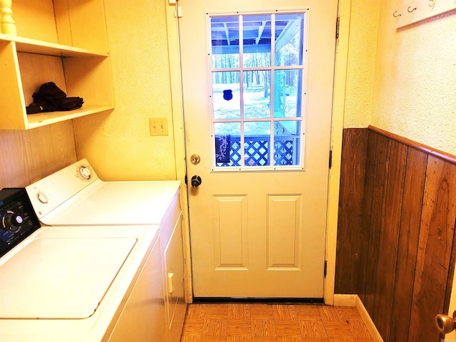 washroom with light parquet floors and separate washer and dryer