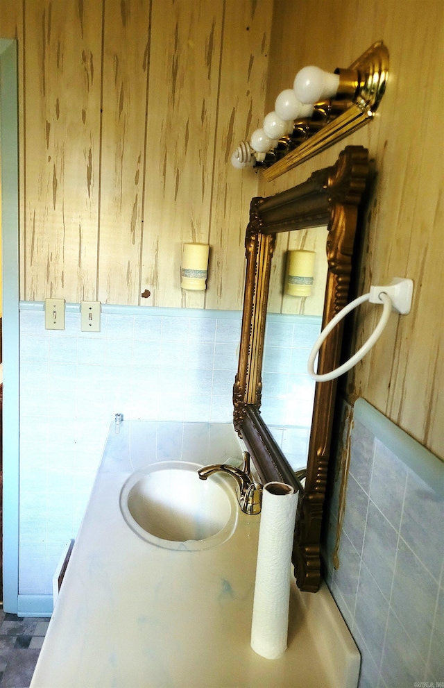 bathroom with wood walls and sink