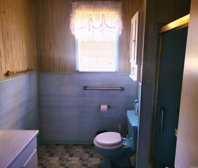 bathroom with vanity, tile walls, toilet, and tile patterned floors