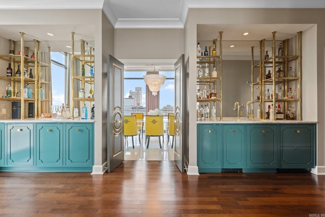 bar featuring dark wood-type flooring, crown molding, and sink