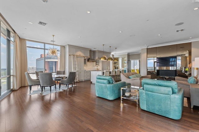 living room with hardwood / wood-style flooring and crown molding