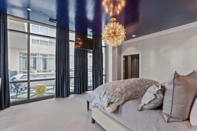 carpeted bedroom featuring an inviting chandelier