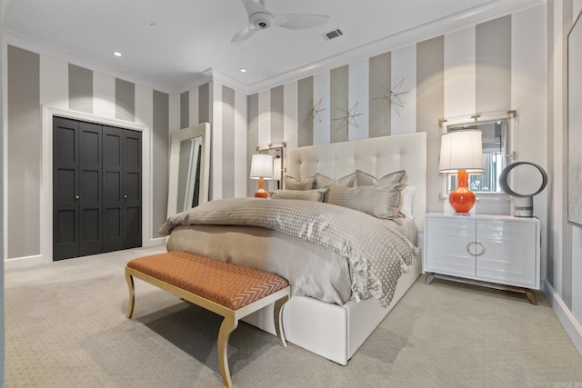 carpeted bedroom with ornamental molding, a closet, and ceiling fan