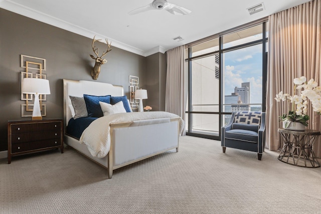 carpeted bedroom with crown molding and ceiling fan