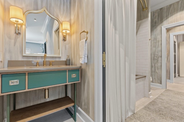 bathroom featuring a shower, vanity, ornamental molding, and tile patterned floors