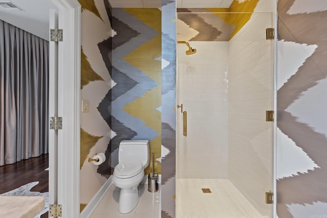 bathroom featuring walk in shower, hardwood / wood-style flooring, and toilet