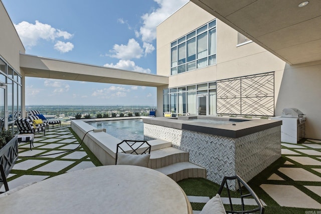 view of patio / terrace featuring grilling area and a water view