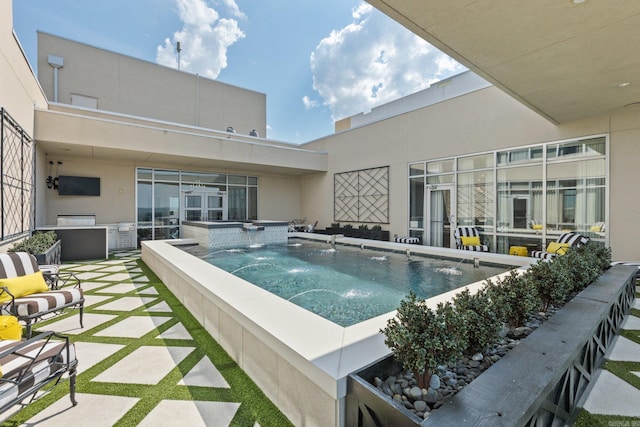 view of swimming pool featuring an in ground hot tub, pool water feature, and a patio area