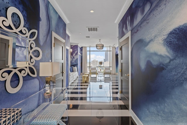 interior space featuring ornamental molding, a wall of windows, and tile patterned floors