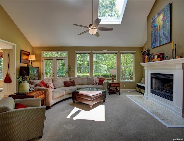 carpeted living room with ceiling fan and lofted ceiling