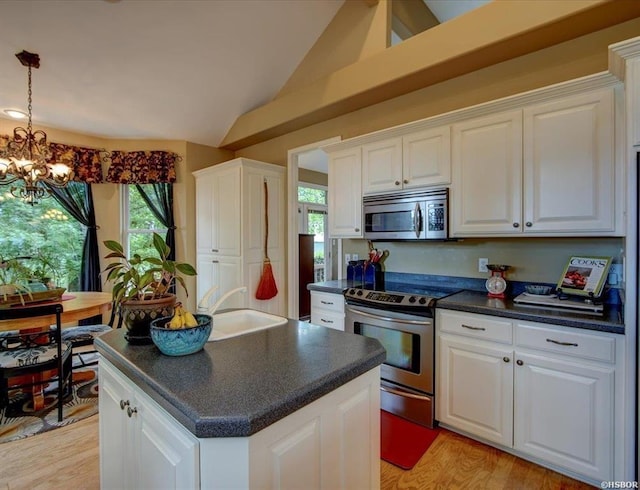 kitchen featuring white cabinets, a center island, and appliances with stainless steel finishes