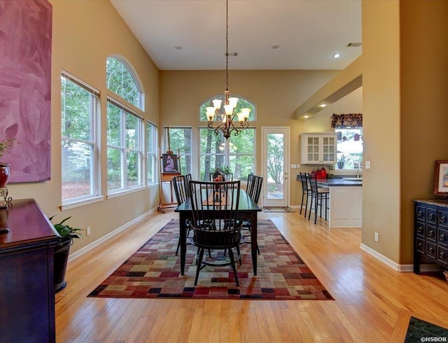 dining area featuring a notable chandelier and light wood-type flooring