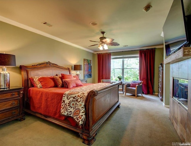 carpeted bedroom featuring a fireplace, ceiling fan, and ornamental molding