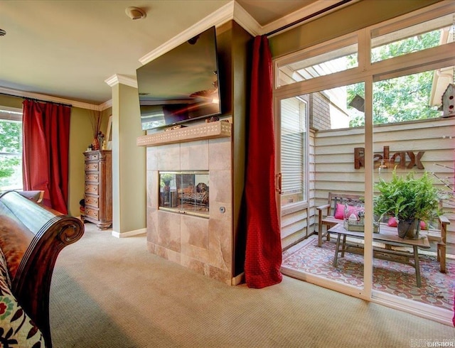 carpeted bedroom with ornamental molding and a tiled fireplace