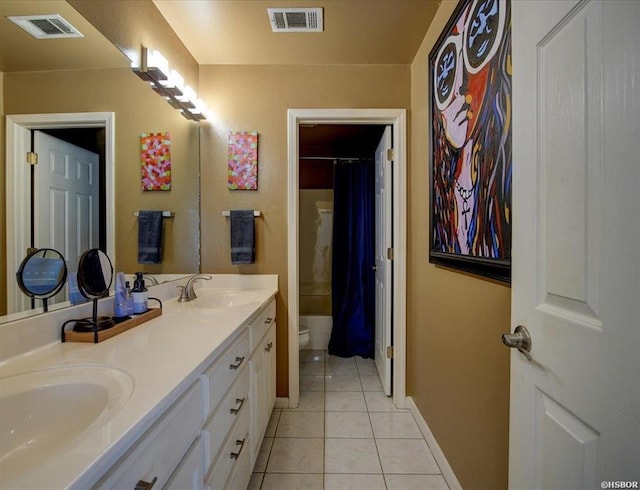 bathroom with vanity, toilet, tile patterned floors, and curtained shower