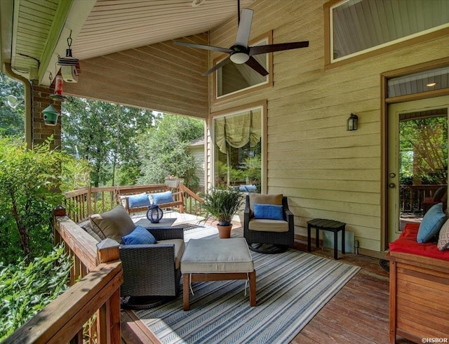 deck with ceiling fan and an outdoor living space