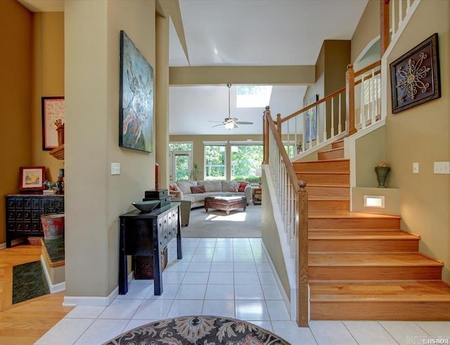 stairway with ceiling fan and tile patterned floors