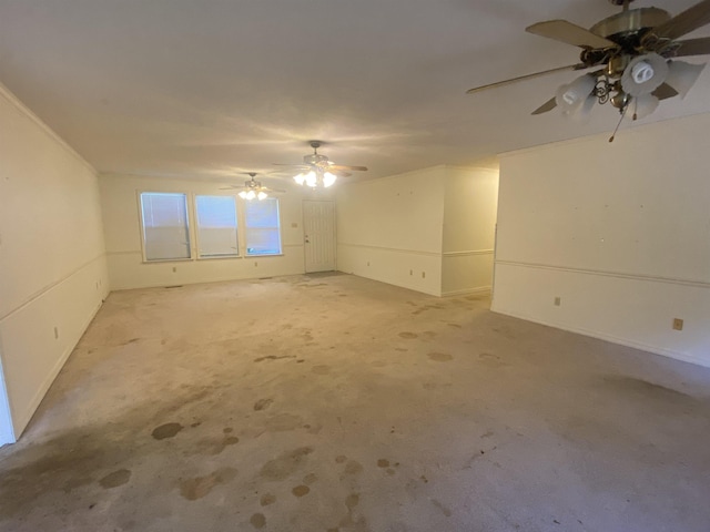 carpeted empty room with ceiling fan and crown molding