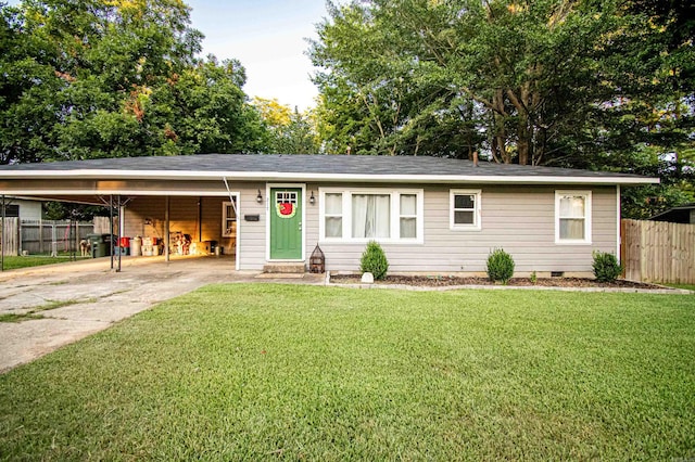 ranch-style house featuring a carport and a front lawn