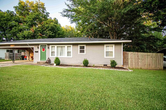 ranch-style house with a carport and a front lawn