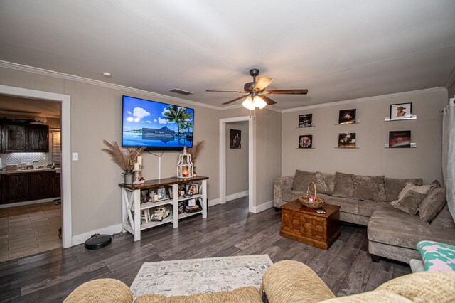 living room featuring ceiling fan, crown molding, and dark wood-type flooring