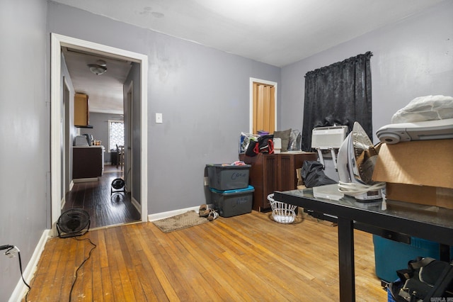 office featuring hardwood / wood-style flooring, baseboards, and baseboard heating