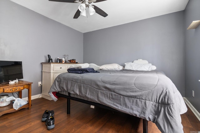 bedroom with wood finished floors, baseboards, and a ceiling fan