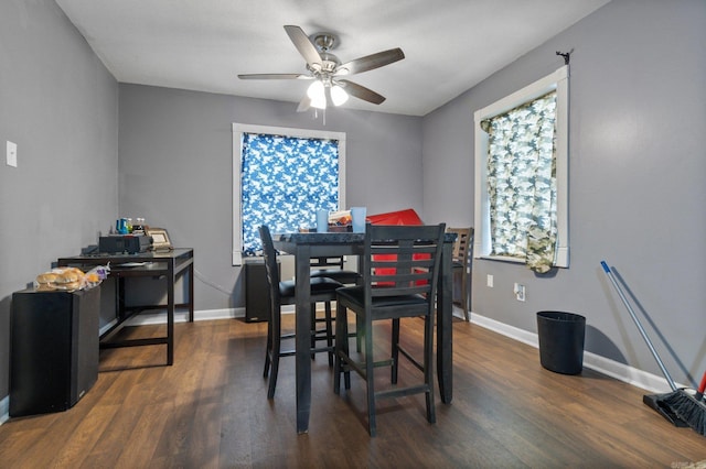 dining space featuring baseboards, a ceiling fan, and wood finished floors