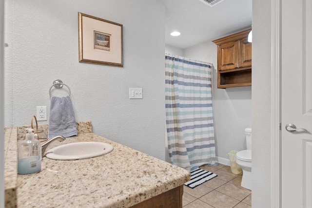 bathroom with a textured wall, toilet, a shower with curtain, tile patterned floors, and vanity