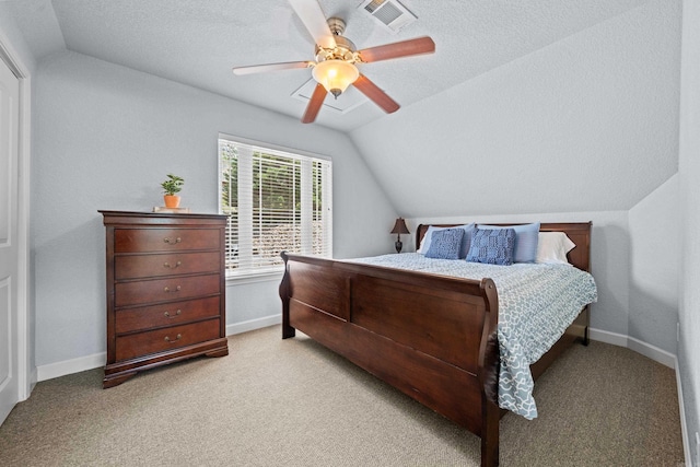 bedroom with visible vents, vaulted ceiling, a textured ceiling, and baseboards