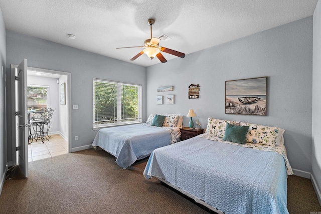 bedroom with visible vents, carpet flooring, ceiling fan, a textured ceiling, and baseboards