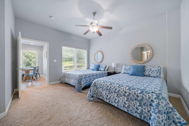 tiled bedroom featuring multiple windows, carpet flooring, and baseboards