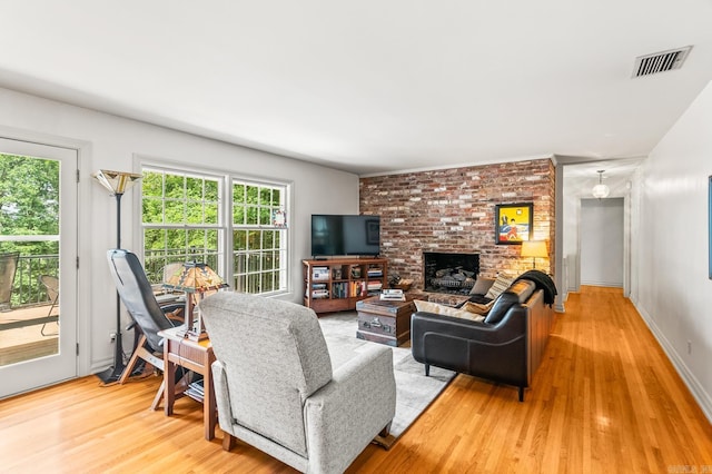 living room with a fireplace and wood-type flooring