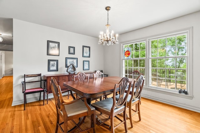 dining area featuring an inviting chandelier and light wood-type flooring