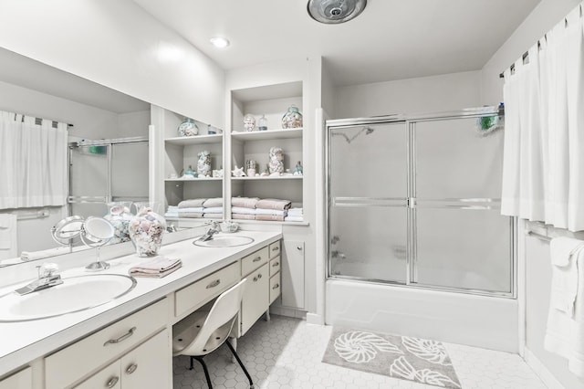 bathroom with tile patterned floors, bath / shower combo with glass door, and vanity