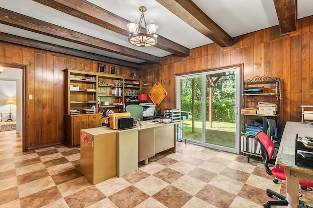 office with a notable chandelier, beam ceiling, built in desk, and wood walls