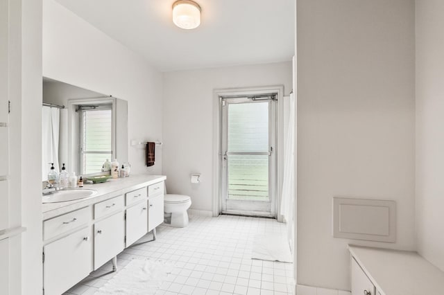 bathroom featuring tile patterned floors, vanity, and toilet