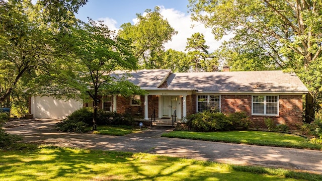 single story home featuring a garage and a front yard