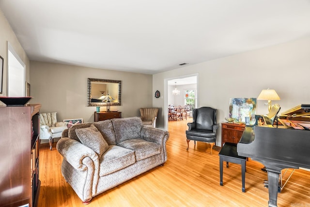 living room featuring hardwood / wood-style flooring and a notable chandelier