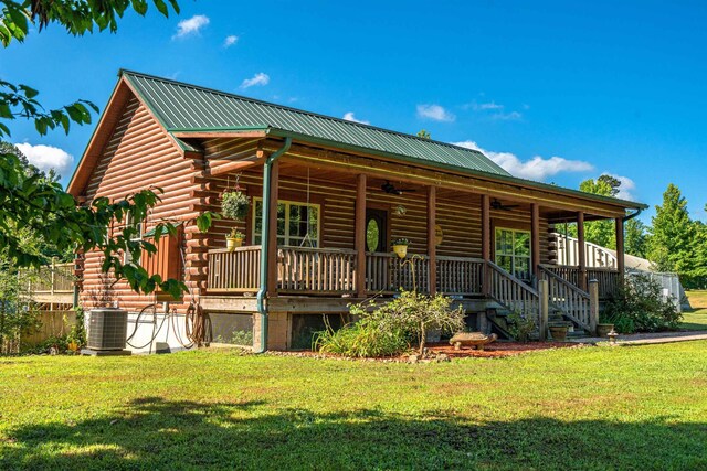 view of front of property with central AC unit and a front lawn