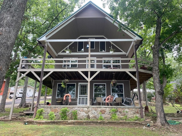 rear view of property with covered porch