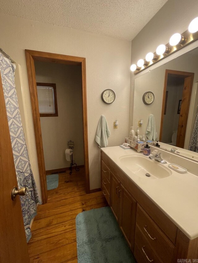 509A Woodland Hills Rd, Hardy, AR 72542 - full bathroom featuring vanity, wood finished floors, and a textured ceiling