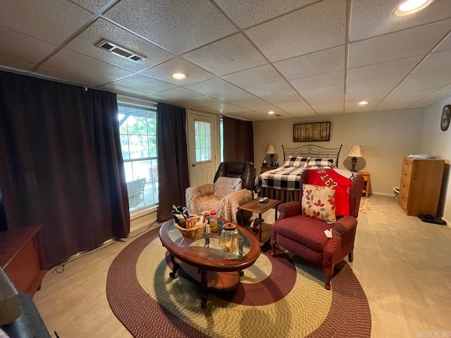 living room featuring a paneled ceiling