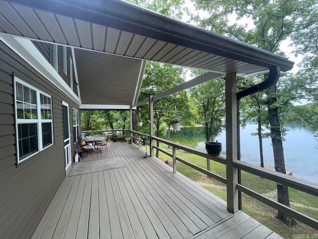 wooden terrace featuring a water view