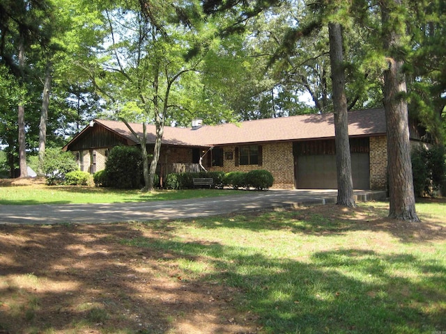 901 Hastey Ave, Mena, AR 71953 - single story home with a garage, driveway, brick siding, and a front yard