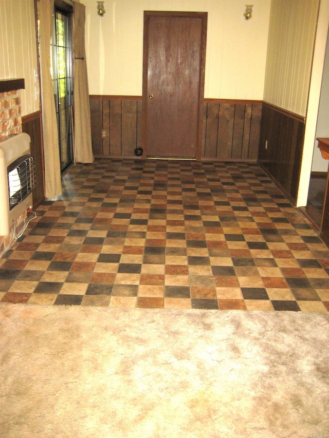 empty room featuring dark tile patterned floors and a fireplace