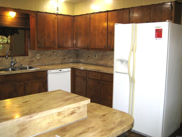 901 Hastey Ave, Mena, AR 71953 - kitchen with a sink, white appliances, backsplash, and brown cabinets